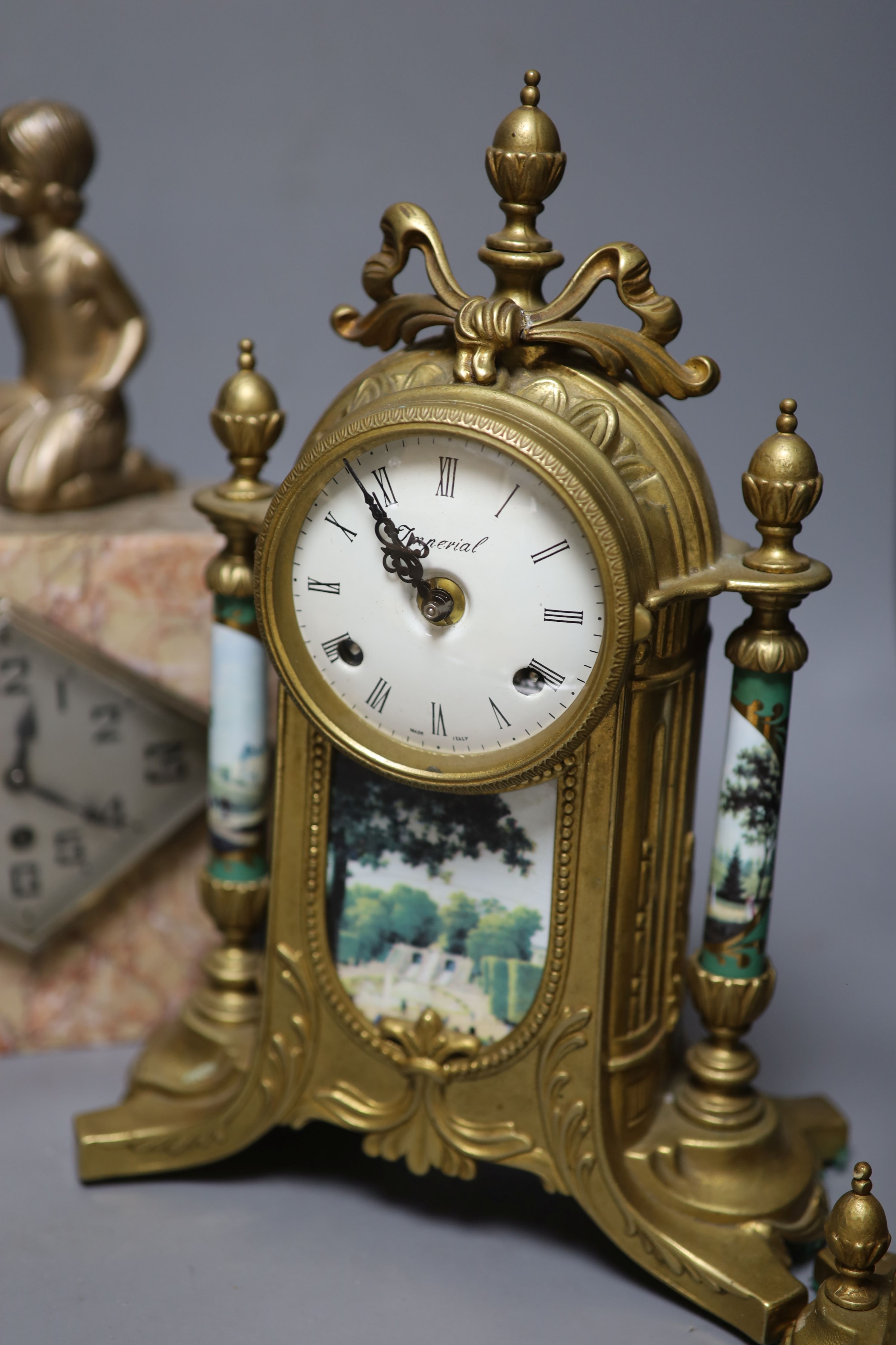 A Louis XV style gilt metal and porcelain three piece clock set and an Art Deco mantel clock, tallest 35cm